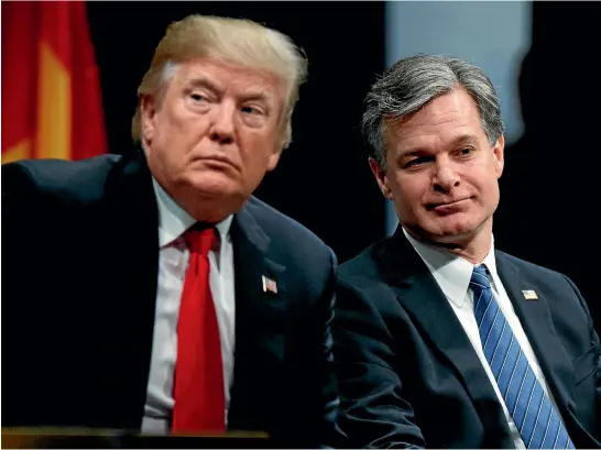  ?? AP ?? US President Donald Trump sits with FBI Director Christophe­r Wray during the graduation ceremony for law enforcemen­t officers at the FBI’s National Academy in Quantico, Virginia. Trump earlier called the FBI ‘‘disgracefu­l’’ and said he wanted to...