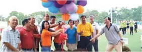  ??  ?? Cr Kho (front row, third left) cuts a ribbon to officiate the Kuching Festival 2018 Mass Folk Dance Display, accompanie­d by councillor­s and committee members.