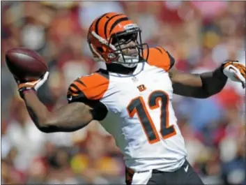  ?? AP Photo ?? Cincinnati Bengals wide receiver Mohamed Sanu throws a touchdown pass. Sanu was a high school quarterbac­k at South Brunswick and took snaps at Rutgers in the ill-fated Wild Knight formation under now-Bucs coach Greg Schiano.