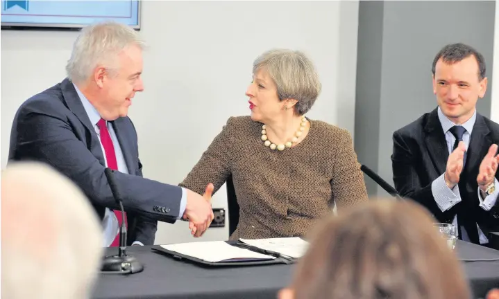  ?? Gayle Marsh ?? > PM Theresa May at Swansea’s Liberty Stadium to sign the £1.3bn Swansea Bay City Region City Deal, with First Minister Carwyn Jones, left, and Secretary of State for Wales Alun Cairns, right