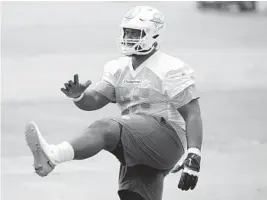  ?? WILFREDO LEE/AP ?? Dolphins guard Robert Jones warms up during a mandatory minicamp at the team’s training camp on June 16in Davie.