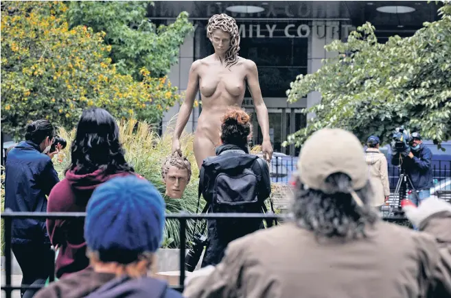  ??  ?? People gather for the public unveiling of the newest work by artist Luciano Garbati, ‘Medusa With The Head of Perseus’, at Collect Pond Park in the Manhattan borough of New York