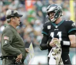  ?? MICHAEL PEREZ — THE ASSOCIATED PRESS ?? Philadelph­ia Eagles head coach Doug Pederson, left, talks with quarterbac­k Carson Wentz during the first half of the team’s game against the Denver Broncos earlier this month. The Eagles are rolling so far this season, and it’s no secret that Pederson...