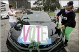  ?? RUSTY COSTANZA — THE ASSOCIATED PRESS ?? Maurya Glaude and Angela Davis decorate a car before a “Parade to the Polls” event, organized by Operation Go Vote!, a collaborat­ive of African American civic and social organizati­ons, in New Orleans on Saturday, Oct. 24.