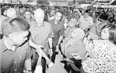  ??  ?? Prime Minister Datuk Seri Najib Tun Razak greeting the public at the opening of the National Cooperativ­es Day 2018 in Ayer Keroh, Melaka. - Bernama photo