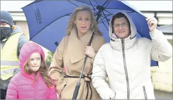  ?? Photo by John Tarrant ?? Kathleen O’Keeffe, Carmel and Leah Fleming take shelter from a shower during the Duhallow 10 Mile Road Race.