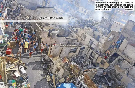  ??  ?? Residents of Barangay 197, Zone 20 in Pasay City sift through the debris of their houses after a fire razed the area yesterday.