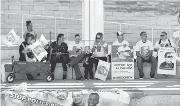  ?? JOSIE LEPE/STAFF PHOTOS ?? The family of AJ Phillips, with supporters, hold posters as they gather Thursday before a rally on National Day of Action, Black Lives Matter at San Jose City Hall.