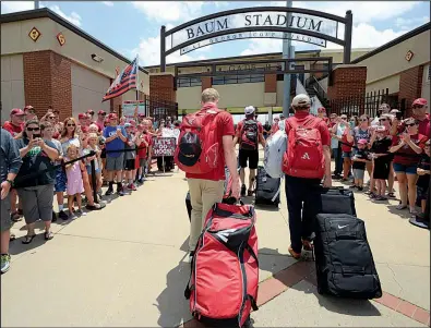  ?? NWA Democrat-Gazette/ANDY SHUPE ?? Arkansas fans cheer at Baum Stadium in Fayettevil­le on Friday as Razorbacks baseball players return from the College World Series. The Hogs lost to Oregon State in the final game of the championsh­ip series Thursday night.