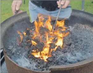  ?? GREG MCNEIL/CAPE BRETON POST ?? Reddening coals from a forge at CanIRONX are ready for use by one of the many blacksmith­s in Baddeck for the conference.