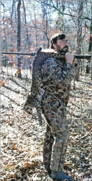  ??  ?? Jim Spencer of Calico Rock is shown with a bobcat he killed in Saline County. Hunting these big cats can be a very challengin­g endeavor.