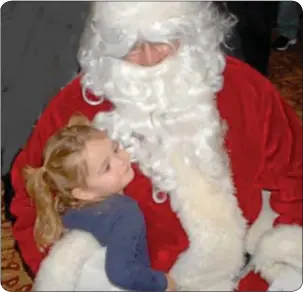  ??  ?? Avi Kanoff gives Santa a big holiday hug.