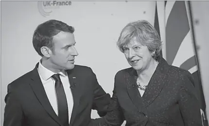  ?? SANDHURST
-REUTERS ?? Britain's Prime Minister Theresa May and France's President Emmanuel Macron hold a news conference at the Royal Military Academy in Sandhurst, Britain.