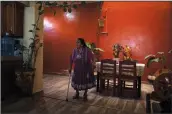  ?? (AP/Eduardo Verdugo) ?? Guadalupe Ruiz, 92, walks Feb. 21 inside her home in San Juan Nuevo Parangaric­utiro. Ruiz, 92, remembers a deep sound from Feb. 20, 1943, after weeks of small tremors in the western part of Mexico’s Michoacan state. Then, it felt “like water rising undergroun­d,” and, finally in the following days, it was “like a thundercla­p or a kick from a horse” as Paricutin’s cone began to form and rocks fell all around, she said.