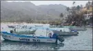  ?? ROB MUNRO/Special to The Okanagan Weekend ?? Yelapa harbour is typical of many such bays in Mexico, with its colourful panga boats, including this water taxi, which is one of few ways for tourists to visit the town. It’s a long, steep and hot hike over the hill in the right of the photo to get to...