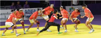 ?? — AFP ?? Indian women kabaddi players try to trap a Japanese raider during their match on Sunday. India won 43- 12.