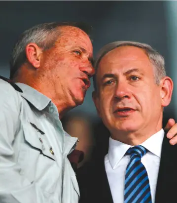  ?? (Reuters/Baz Ratner) ?? CAN THEY find a way to embrace one another in the same government? Netanyahu and Gantz in better days.