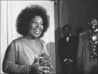  ?? AP PHOTO, FILE ?? In this March 1974 photo, Roberta Flack holds the Grammy award for record of the year for "Killing Me Softly With His Song" at the 16th annual Grammy Awards in Los Angeles. Flack, one of only two artists who have won the category two years in a row,...