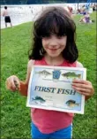  ?? John Hayes/Post-Gazette ?? Mary Abranovich, 9, of Pulaski, Pa., caught her first fish, a sunfish, at the PostGazett­e Family Fishing Area on Aug. 7 at the Moraine State Park Regatta.