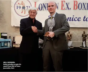  ?? Photo: MARTIN SAX ?? WELL DESERVED: Daley proudly accepts his award from Hall of Fame journalist, Hart