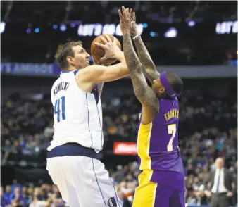  ?? Ron Jenkins / Getty Images ?? Seven-foot forward Dirk Nowitzki of the Mavericks looks to shoot against recent Lakers acquisitio­n Isaiah Thomas, who’s all of 5-foot-9, in the second half of Dallas’ comeback win.