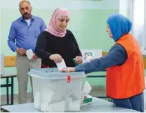  ?? — AFP ?? A Palestinia­n woman casts her ballot during the municipal elections in the West Bank city of Ramallah on Saturday.