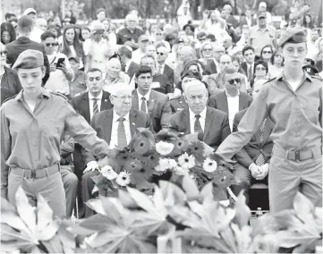  ?? — AFP photo ?? Netanyahu (centre) and Rivlin (left) attend a ceremony marking the annual Holocaust Remembranc­e Day at Yad Vashem Holocaust Memorial in Jerusalem.