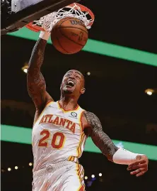  ?? Kevin C. Cox / Getty Images ?? John Collins had 23 points in the Hawks’ 129-111 win over the Magic. Atlanta’s Trae Young also scored 23.