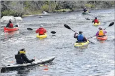  ?? KATHY JOHNSON ?? Canoes and kayaks are paddled downstream towards the mouth of the Barrington River and the end of the annual river run on May 12.