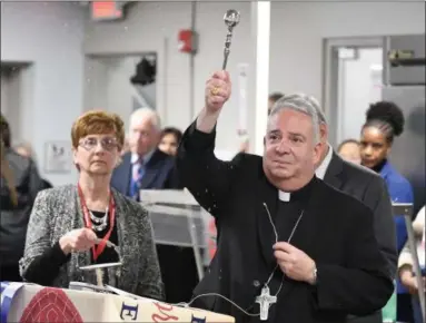  ?? ERIC BONZAR — THE MORNING JOURNAL ?? Bishop Nelson J. Perez blesses the St. Elizabeth Center during a dedication ceremony of Catholic Charities of the Diocese of Cleveland’s, 50-bed, men’s year-round shelter located at 2726 Caroline Ave., in Lorain, Oct. 31.