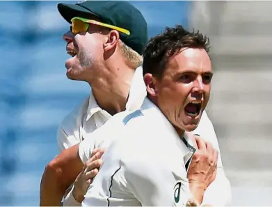  ??  ?? Star of the day: Australia’s Steve O’Keefe (right) celebratin­g with David Warner on the second day of the first Test against India at Maharashtr­a Cricket Associatio­n Stadium in Pune yesterday. — AFP