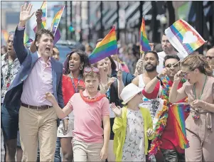  ?? CP PHOTO ?? Prime Minister Justin Trudeau, his wife Sophie Gregoire Trudeau and their children Ella-Grace and Xavier walk in the Pride parade in Toronto, Sunday.