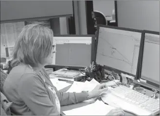  ?? Mona Weatherly ?? When there is a power outage, CPPD Assistant Operation Manager Cindy Lindner, above, helps dispatch crews. At right, Custer Solutions Representa­tive Angie Flynn is one of three who answer phones and take reports of outages. Communicat­ion through Paige Wireless’ LoRaWAN® network may help CPPD identify trouble spots a bit quicker.