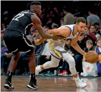  ?? — AFP ?? Stephen Curry of the Golden State Warriors drives down the court against Caris LeVert (22) of the Brooklyn Nets.