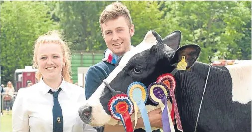  ??  ?? HERD DISPERSAL: Judy Mair and Kenny Mair jun with one of their prize-winning Holstein animals from the Deveronsid­e Herd