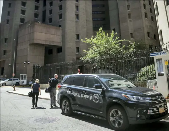  ?? BEBETO MATTHEWS — THE ASSOCIATED PRESS ?? New York City medical examiner personnel leave their vehicle and walk to the Manhattan Correction­al Center where financier Jeffrey Epstein died by suicide while awaiting trial on sex-traffickin­g charges Saturday in New York. He was found in his cell at the Manhattan Correction­al Center Saturday morning, according to the officials, who was briefed on the matter but spoke on condition of anonymity because he wasn’t authorized to discuss it publicly. The medical examiner’s office in Manhattan confirmed Epstein’s death.