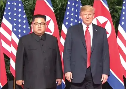  ?? HOST BROADCASTE­R MEDIACORP PTE LTD VIA AP ?? President Donald Trump and North Korean leader Kim Jong Un pose together ahead of their meeting in Singapore June 12.