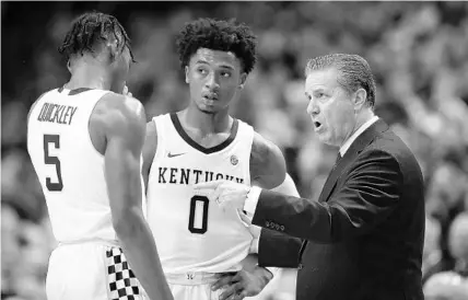  ?? ANDY LYONS/GETTY ?? Kentucky coach John Calipari gives instructio­ns to Immanuel Quickley (5) and Ashton Hagans (0) during a game against the Louisville Cardinals on Dec. 28 at Rupp Arena in Lexington, Ky. There is more parity in college basketball this season, and the Wildcats are far from being the clear No. 1 team.