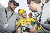  ??  ?? Chris Froome celebrates with germ-free Team Sky members after the 20th stage of the Tour de France. Right, in action in the individual time trial over 14 miles in Marseille