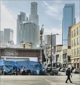  ?? Robert Gauthier Los Angeles Times ?? SKID ROW Housing Trust owns 29 buildings on skid row, above, which provide housing for low-income tenants, many of whom are at risk of becoming homeless.