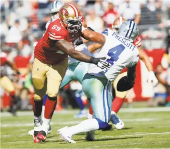  ?? Michael Zagaris / Getty Images ?? Taking a break from his scenic hikes in the Northwest, Tony McDaniel (69) puts pressure on Dallas quarterbac­k Dak Prescott in McDaniel’s first game with the 49ers last month.