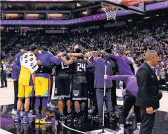  ?? Photos by Lachlan Cunningham / Getty Images ?? Warriors and Kings players come together to pray for Patrick McCaw after he was taken off the court on a stretcher following a fall during the third quarter at Golden 1 Center in Sacramento.