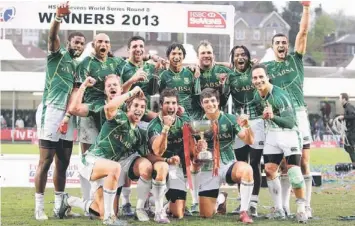  ?? — AFP photo ?? FINAL JOY: The South African team pose with the winners’ trophy after beating New Zealand in a rugby union sevens Cup final match, at the IRB Glasgow Sevens at Scotstoun Stadium.