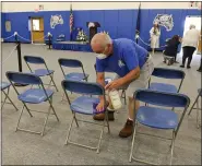  ?? BEN HASTY — MEDIANEWS GROUP ?? Oley Valley High School custodian Carl Forster disinfects each of the seats used by family of the graduates at Oley Valley High School where the district was holding graduation ceremonies for the 2020senior­s one at a time Wednesday afternoon.