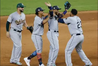  ?? The Associated Press ?? American League teammates celebrate winning the MLB baseball All-Star Game, Tuesday, July 11, 2017, in Miami.