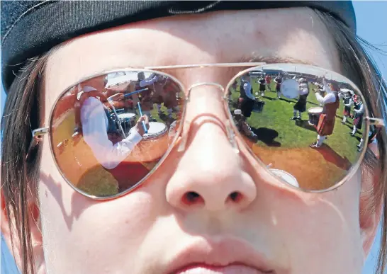  ?? Photo: MARTIN DE RUYTER/FAIRFAX NZ ?? Game face: Claire Martin-Hamilton, of the City of Nelson Highland Pipe Band, prepares to perform at the national pipe band championsh­ips at Trafalgar Park yesterday.