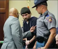  ?? ROGELIO V. SOLIS / AP ?? Joshua Hartfield (center), a former Richland police officer and one of six former Mississipp­i law enforcemen­t officers who pleaded guilty to a long list of state and federal charges enters the Rankin County Circuit Court to listen to the victims’ impact statements, prior to the state sentencing for his involvemen­t in the 2023 racially motivated torture of two black men, on Wednesday in Brandon, Mississipp­i.