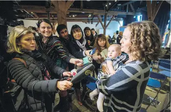  ?? ARLEN REDEKOP ?? Emilie Stevens, with her five-month old daughter Lily Coe, talks to reporters about the fateful day when mom prevented a suicidal woman from leaping to her death off the Granville Street Bridge.