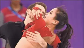  ?? ROBERT DEUTSCH, USA TODAY SPORTS ?? South Korean ice dance partners Yura Min and Alexander Gamelin deal with a wardrobe malfunctio­n during the Olympic team competitio­n.