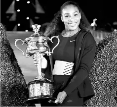  ??  ?? This file photo taken on Jan 29 shows Serena Williams posing with the championsh­ip trophy after her victory against her sister Venus in the women’s singles final at the Australian Open tennis tournament in Melbourne. — AFP photo